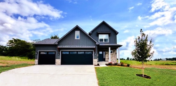 view of front of house featuring a front yard and a garage