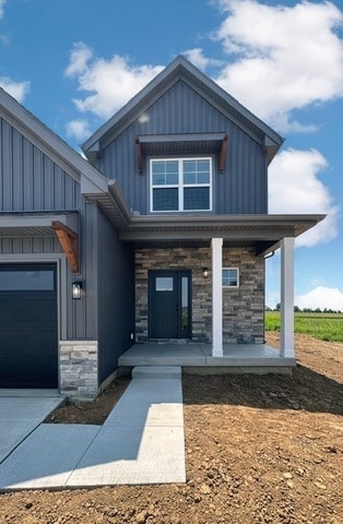 view of front of home featuring a porch and a garage