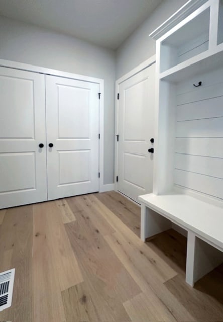 mudroom with light hardwood / wood-style floors