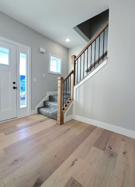 foyer entrance with light hardwood / wood-style floors