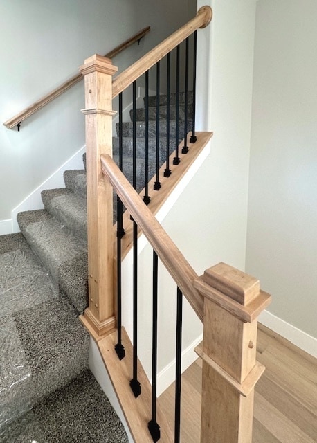 staircase with light hardwood / wood-style flooring