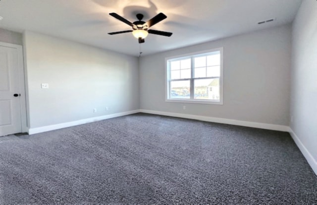 carpeted spare room with ceiling fan