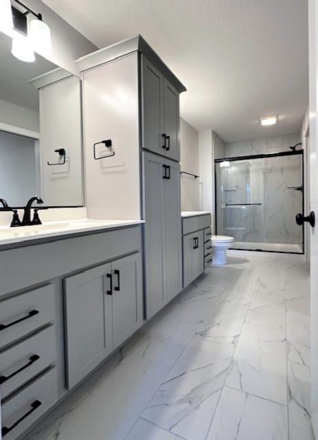 bathroom with an enclosed shower, toilet, tile floors, and vanity