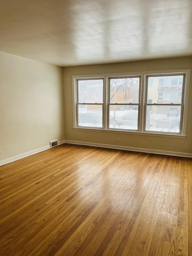 spare room with light wood-type flooring