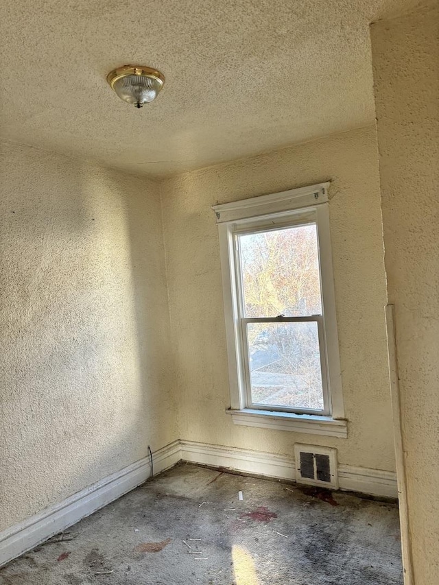 empty room with a textured ceiling