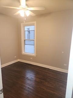 unfurnished room with ceiling fan and dark wood-type flooring