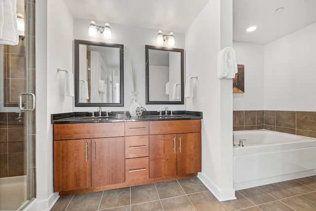 bathroom with separate shower and tub, dual sinks, tile floors, and oversized vanity