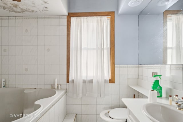 bathroom featuring tile walls, toilet, a tub, and vanity