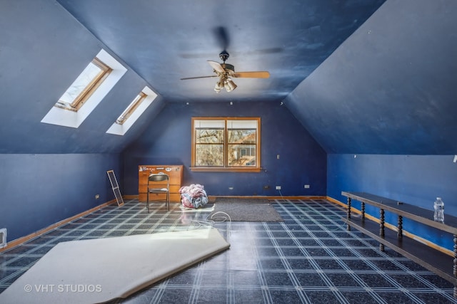 game room featuring ceiling fan and lofted ceiling with skylight