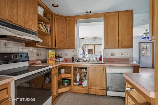 kitchen with white appliances, backsplash, ceiling fan, and sink