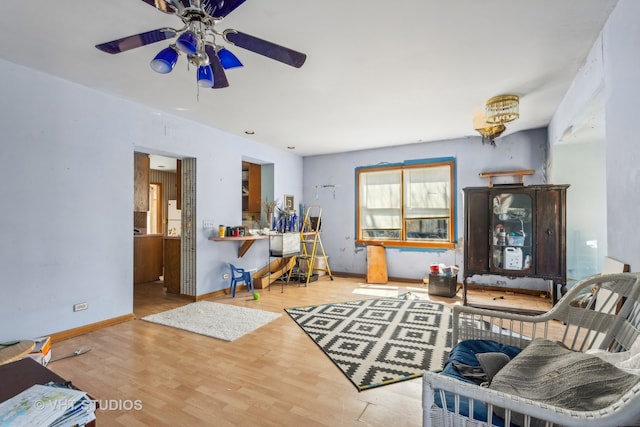 living room featuring ceiling fan and light wood-type flooring