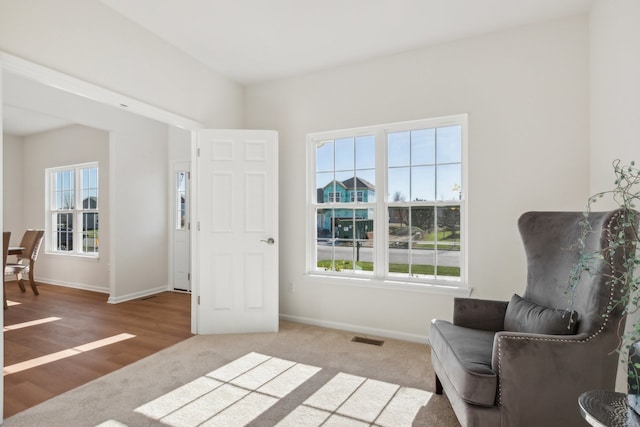 sitting room featuring hardwood / wood-style floors and a healthy amount of sunlight