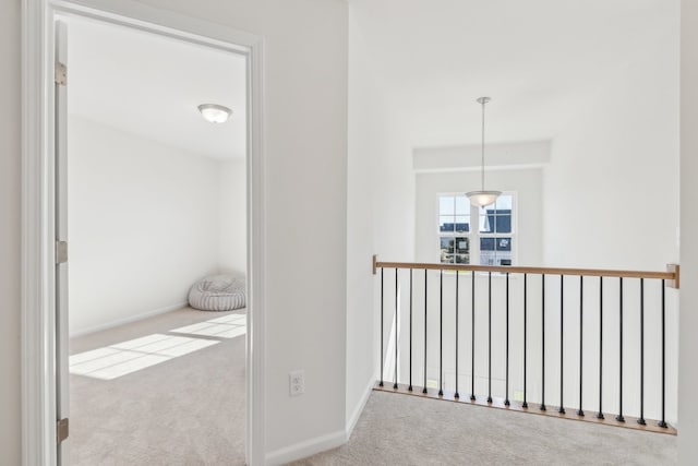 hall with light colored carpet