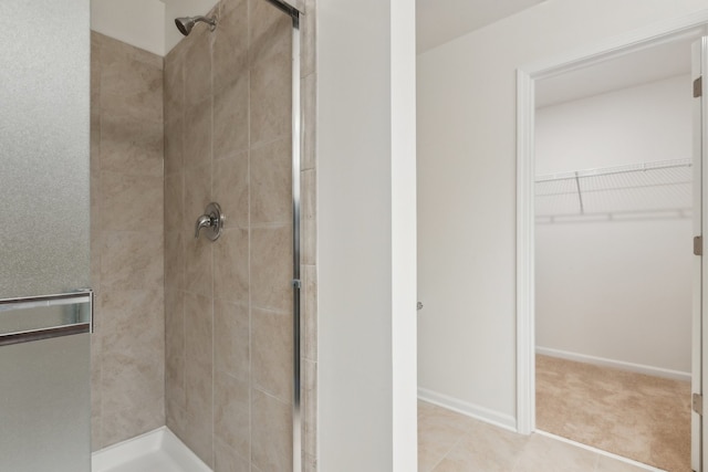 bathroom featuring tile patterned floors and a shower with shower door