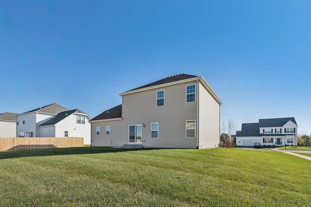 back of property featuring a lawn