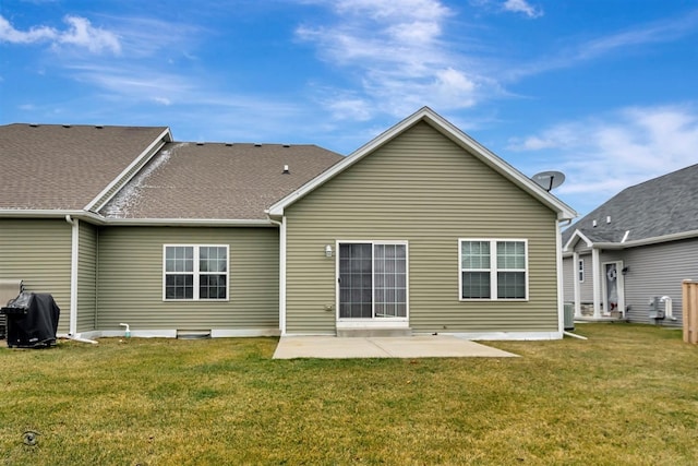 rear view of house with a yard and a patio area