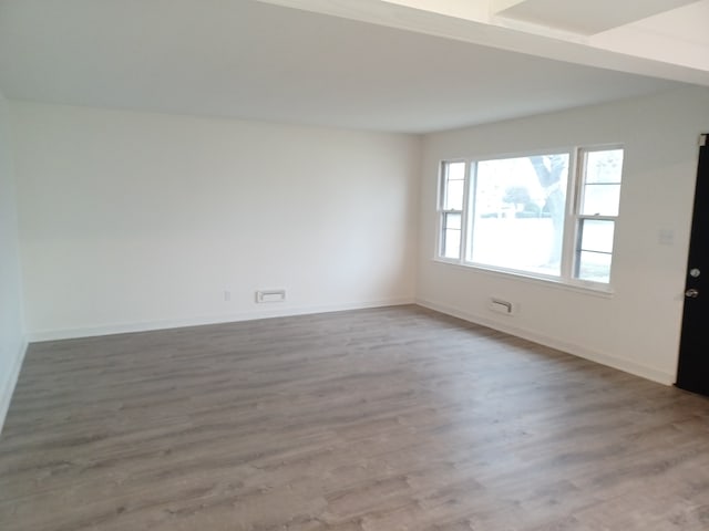 unfurnished room with hardwood / wood-style floors