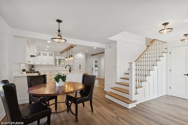 dining area with wood-type flooring and sink