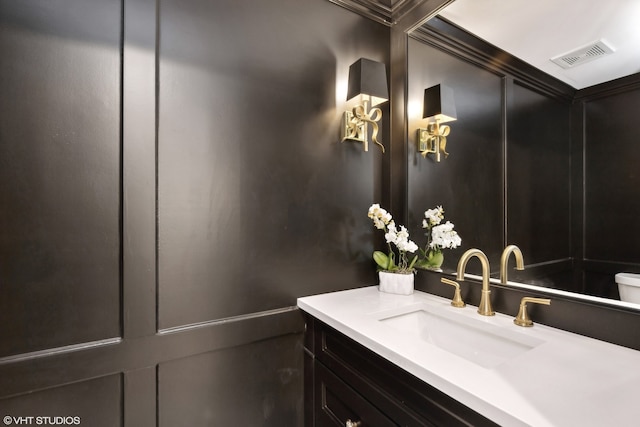 bathroom featuring toilet and vanity