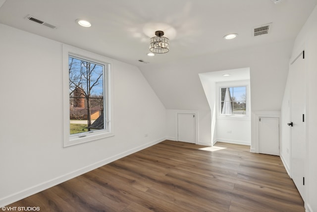 bonus room with lofted ceiling and hardwood / wood-style flooring