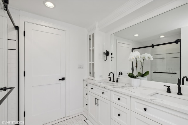 bathroom with a shower with door, vanity, ornamental molding, and tile patterned floors