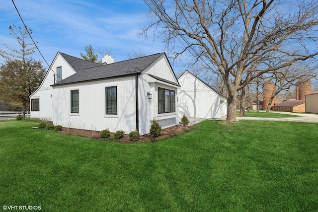 view of side of property with a yard