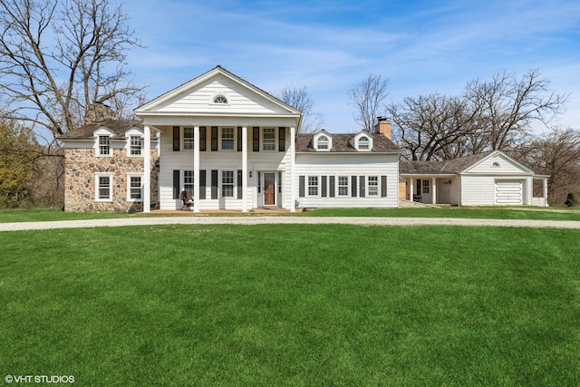 neoclassical / greek revival house featuring a front yard and a porch