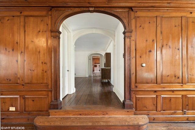 hall featuring ornamental molding and dark hardwood / wood-style floors