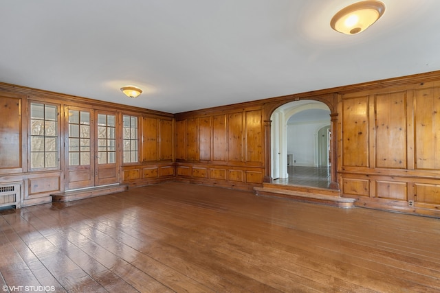 unfurnished living room with wood walls and dark hardwood / wood-style floors