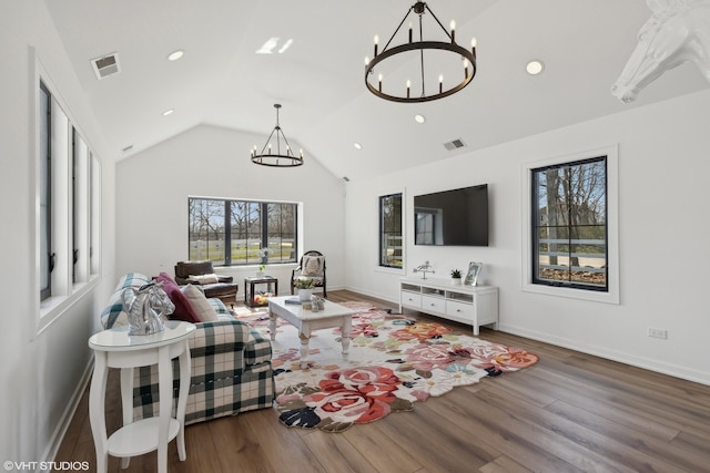 living room with vaulted ceiling, a chandelier, and dark hardwood / wood-style floors