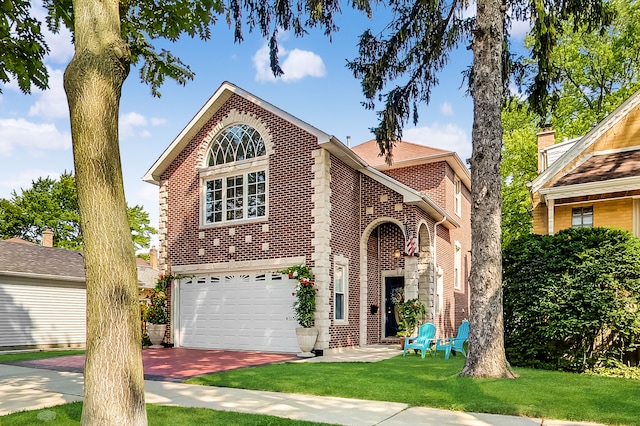 view of property with a garage and a front lawn