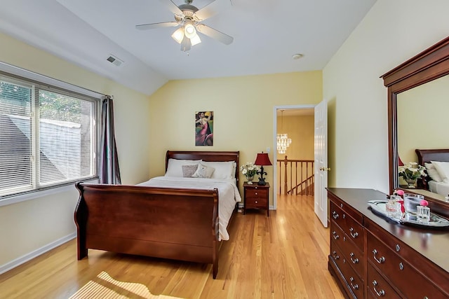 bedroom featuring ceiling fan, light hardwood / wood-style flooring, and lofted ceiling