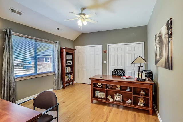 office featuring light hardwood / wood-style flooring, lofted ceiling, and ceiling fan