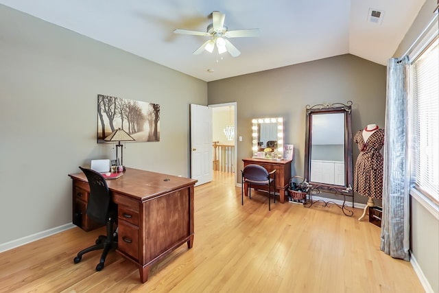 home office featuring ceiling fan, light wood-type flooring, and vaulted ceiling