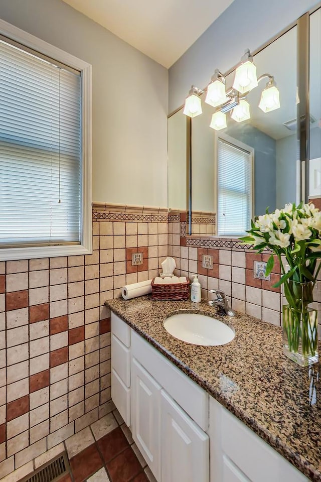 bathroom featuring tile walls, vanity, and tile patterned flooring