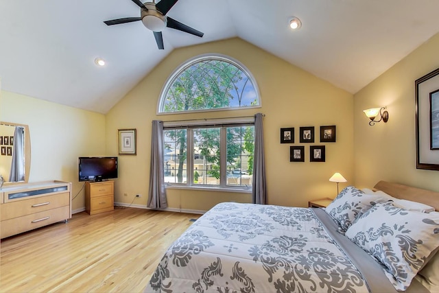 bedroom featuring light hardwood / wood-style floors, ceiling fan, and vaulted ceiling