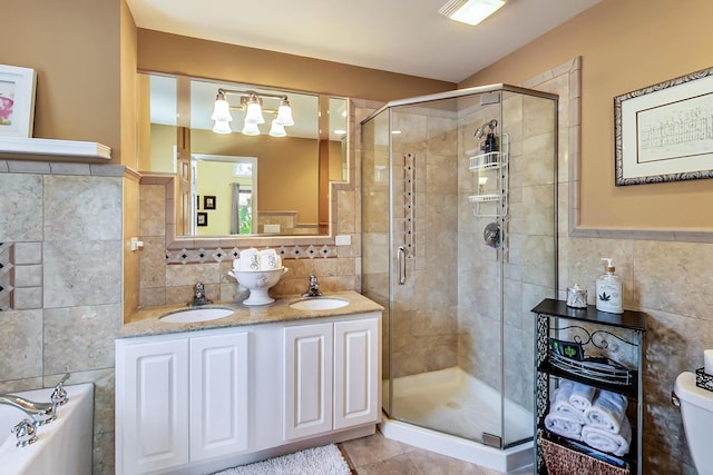 full bathroom featuring toilet, vanity, tile patterned floors, and separate shower and tub