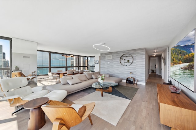 living room with light hardwood / wood-style flooring and a wall of windows