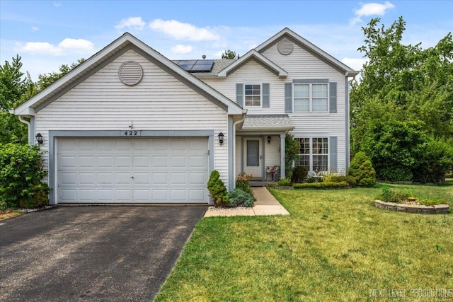 422 Rachel Cir, Romeoville, IL 60446 - traditional-style home featuring driveway, roof mounted solar panels, a front lawn, and a garage