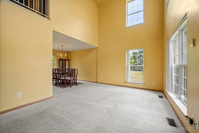 422 Rachel Cir, Romeoville, IL 60446 - carpeted living area with a chandelier and a towering ceiling
