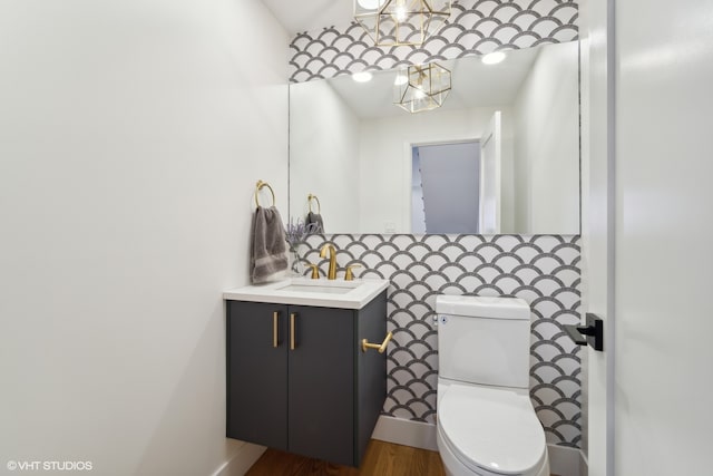 bathroom with backsplash, toilet, vanity, and wood-type flooring