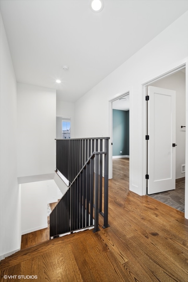 stairway with dark hardwood / wood-style flooring