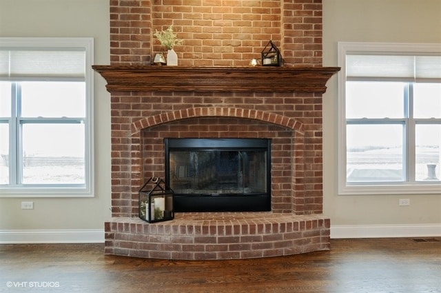 details featuring hardwood / wood-style floors and a brick fireplace