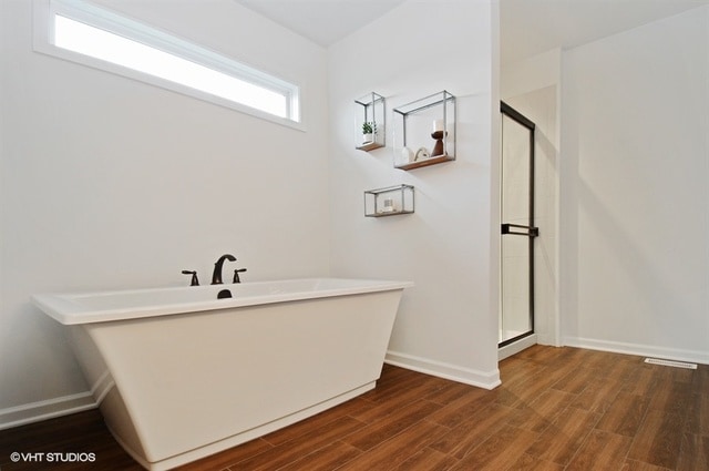 bathroom with hardwood / wood-style floors and walk in shower