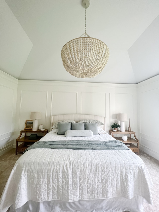 carpeted bedroom featuring a notable chandelier and vaulted ceiling