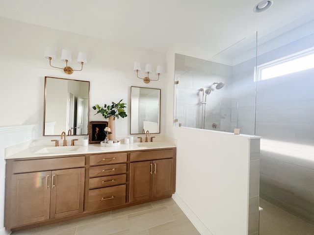 bathroom featuring tile flooring, dual sinks, a shower with door, and large vanity