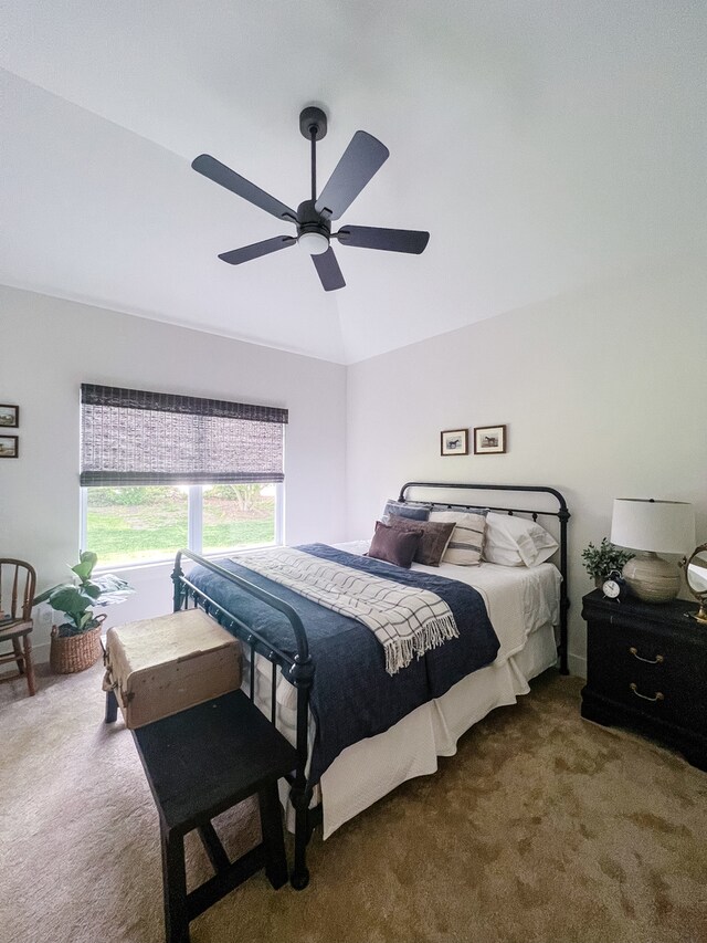 bedroom featuring ceiling fan, lofted ceiling, and dark colored carpet