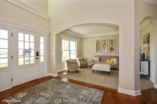 entryway with crown molding and dark hardwood / wood-style floors