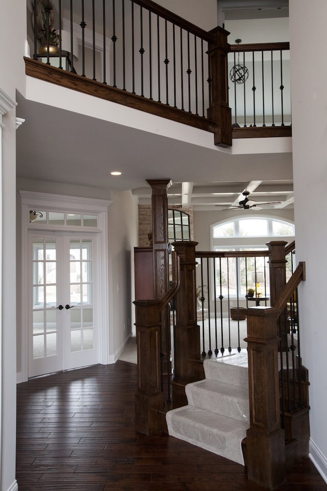 staircase with dark hardwood / wood-style flooring, french doors, and ceiling fan