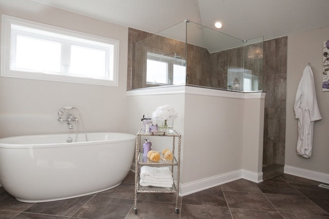 bathroom featuring tile flooring and plus walk in shower